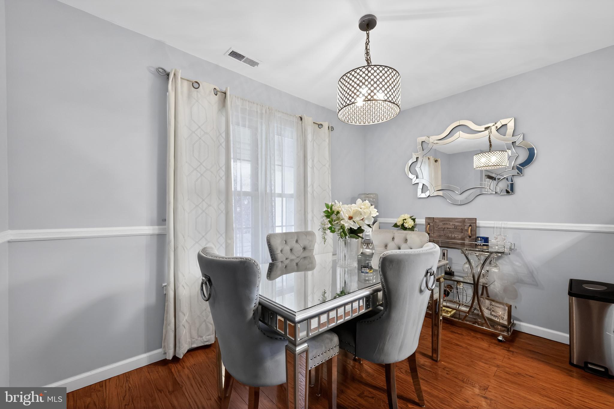213 Tavistock Road Cherry Hill, NJ 08034 - Photo 8 of 24 a dining room with furniture wooden floor and a chandelier
