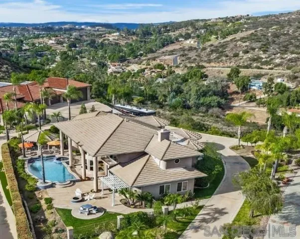 a large kitchen with kitchen island a large counter top appliances and a chandelier