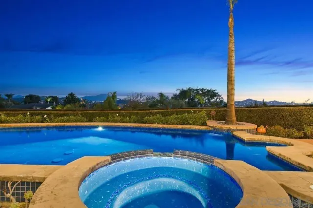 a dining hall with stainless steel appliances granite countertop a sink and a large window