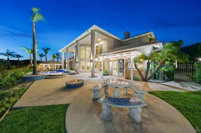 a living room with furniture pool table and chairs