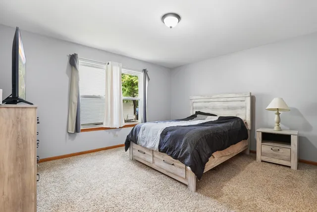 a spacious bedroom with a bed and a window