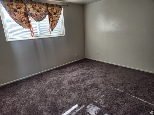 705 North 700 East Payson, UT 84651 - Photo 27 of 30 Spare room featuring baseboards and dark colored carpet