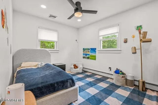 a bedroom with a bed dresser and a window