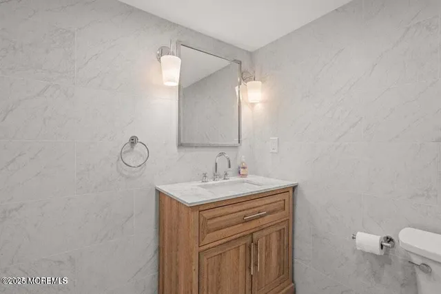 a bathroom with a sink a toilet and a mirror