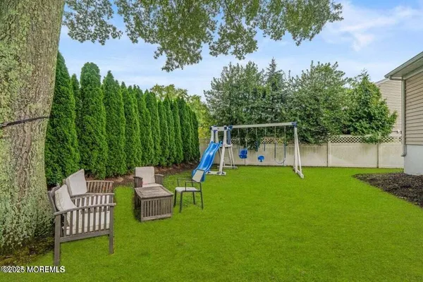 a view of a chair and table in the backyard