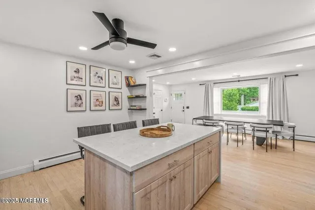 a kitchen with a stove a table and chairs in it
