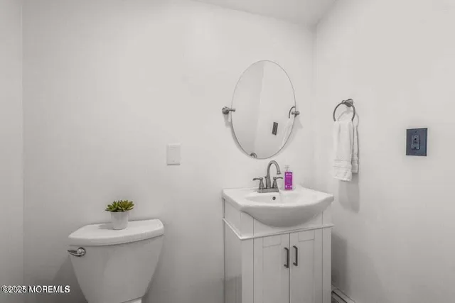 a bathroom with a sink toilet and a mirror