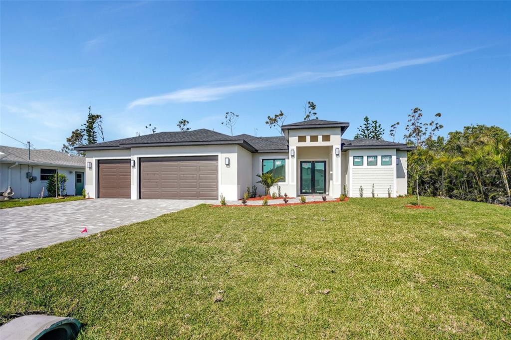 212 Fairway Road Rotonda West, FL 33947 - Photo 11 of 65 a view of a house with a garden and yard