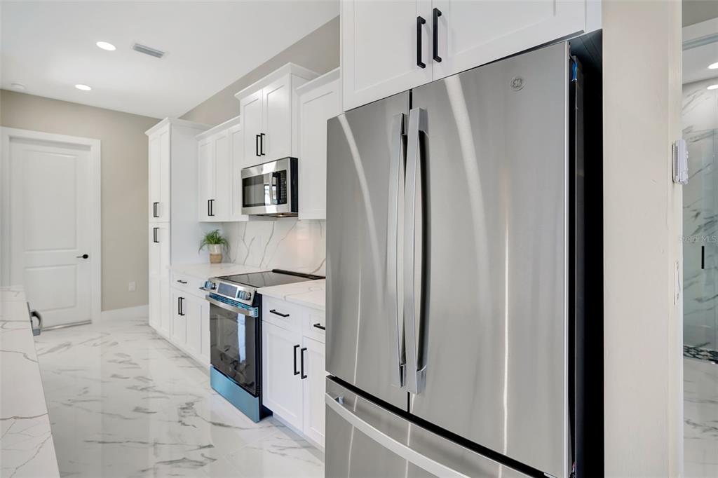 212 Fairway Road Rotonda West, FL 33947 - Photo 16 of 65 a kitchen with stainless steel appliances a refrigerator sink and stove