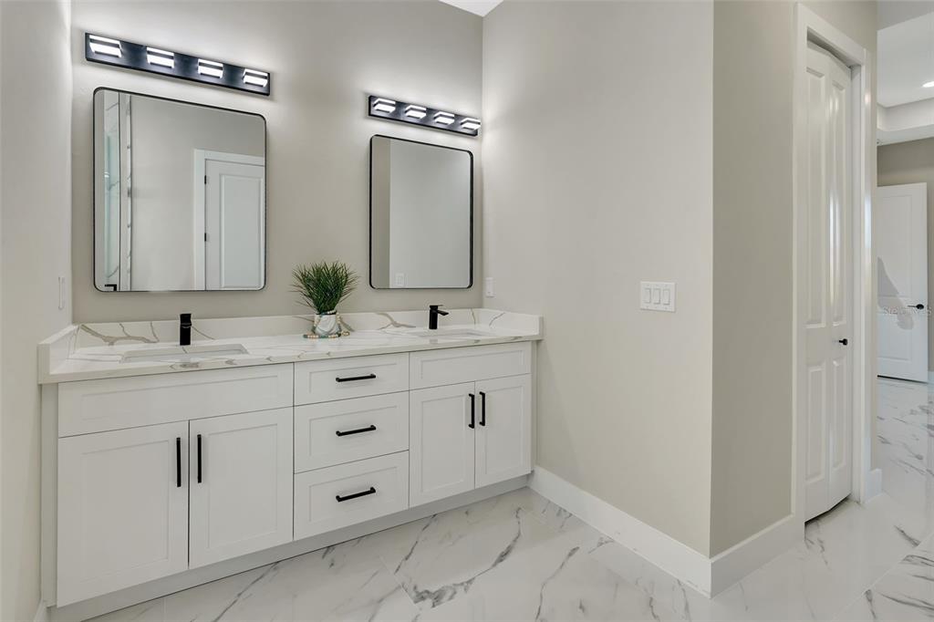 212 Fairway Road Rotonda West, FL 33947 - Photo 32 of 65 a bathroom with double sink and a mirror