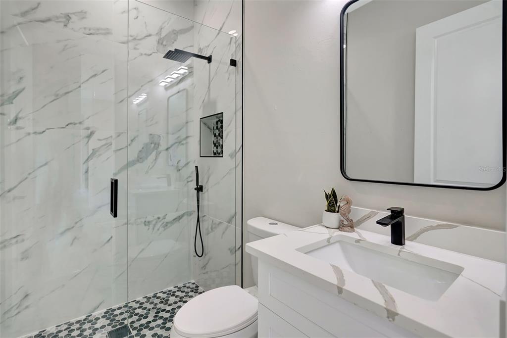 212 Fairway Road Rotonda West, FL 33947 - Photo 38 of 65 a bathroom with a sink toilet and shower