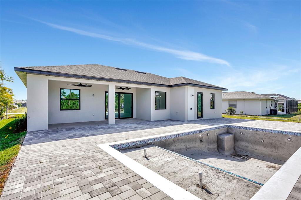 212 Fairway Road Rotonda West, FL 33947 - Photo 45 of 65 a view of a house with a swimming pool and sitting area