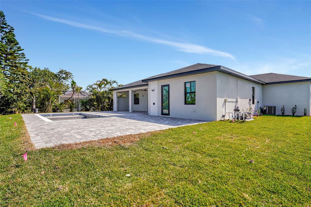 212 Fairway Road Rotonda West, FL 33947 - Photo 47 of 65 a view of a house with backyard and chairs