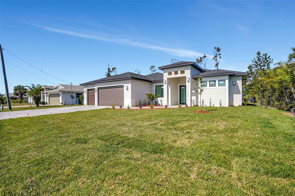 212 Fairway Road Rotonda West, FL 33947 - Photo 48 of 65 a front view of a house with a garden