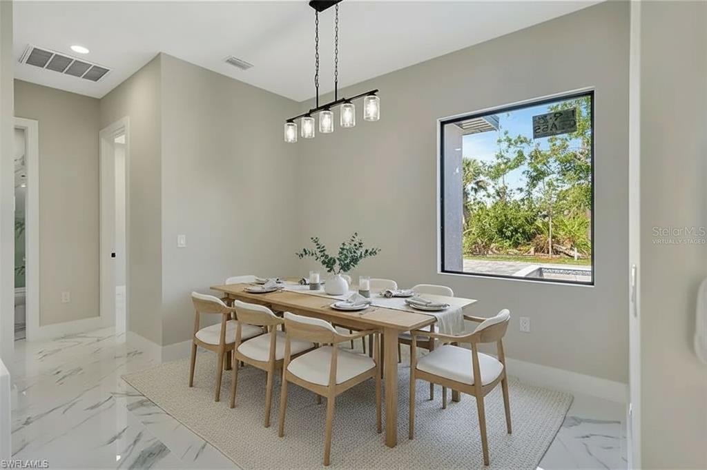 212 Fairway Road Rotonda West, FL 33947 - Photo 5 of 65 a view of a dining room with furniture window and outside view