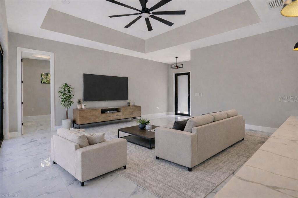 212 Fairway Road Rotonda West, FL 33947 - Photo 8 of 65 a living room with furniture and a flat screen tv