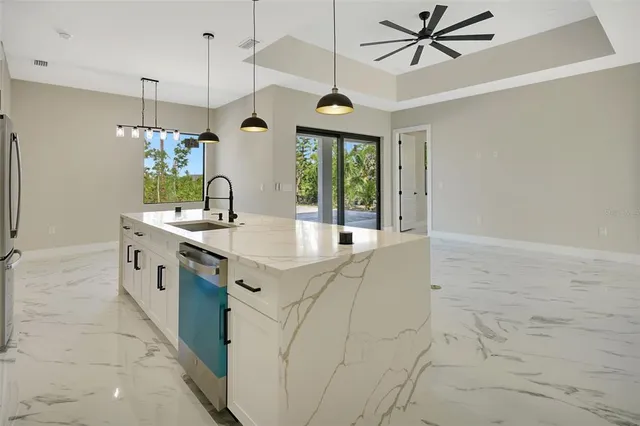 a white kitchen with cabinets and stainless steel appliances