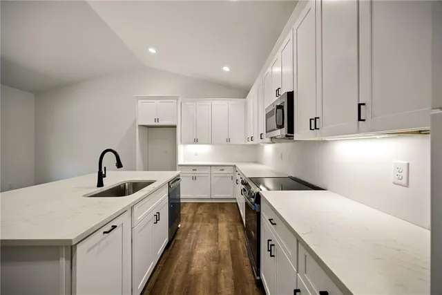 a kitchen with a sink stove and cabinets