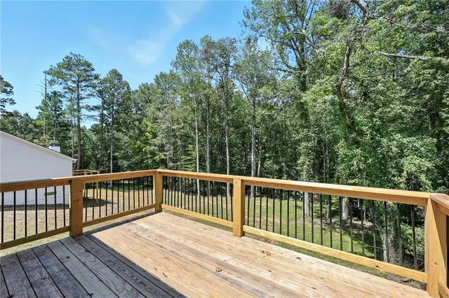 a view of balcony with wooden floor and fence