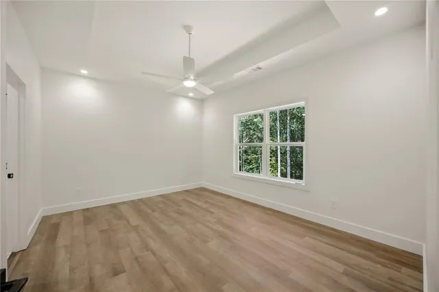 wooden floor in an empty room with a window