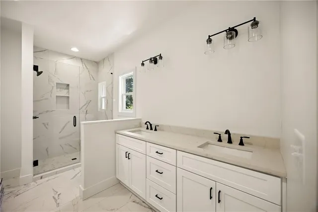 a bathroom with a shower sink and mirror