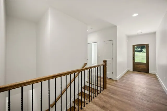 a view of a hallway with wooden floor