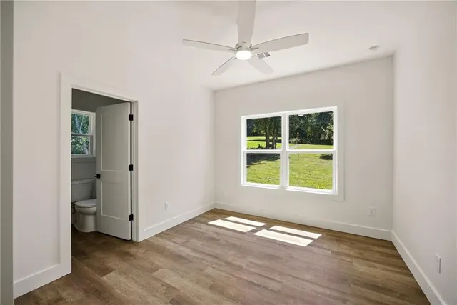 an empty room with wooden floor and a window