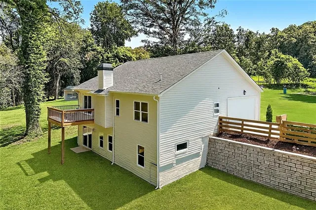 a view of house with backyard and seating area