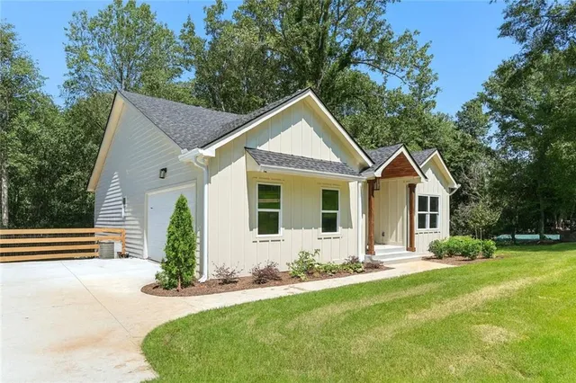 a front view of house with yard and green space