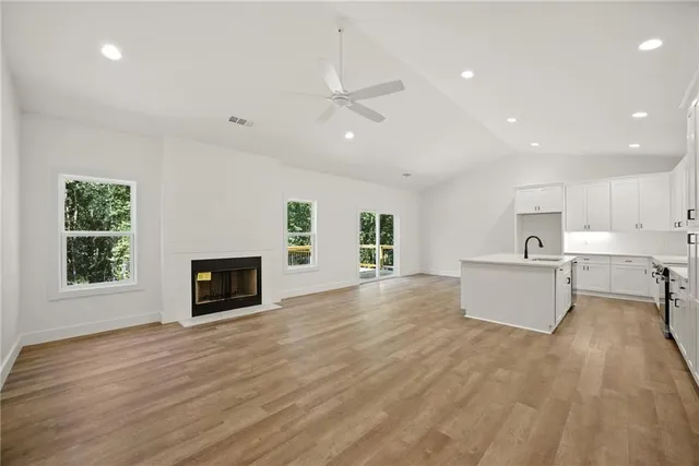 a view of a kitchen with furniture and wooden floor