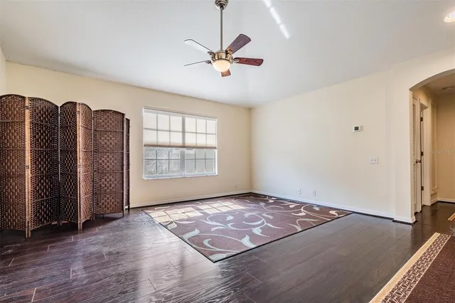 a view of a livingroom with a ceiling fan and window