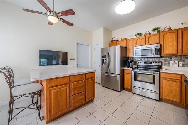 a kitchen with stainless steel appliances a stove microwave and refrigerator