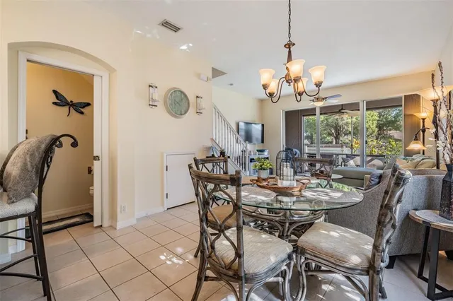 a view of a dining room with furniture and a chandelier