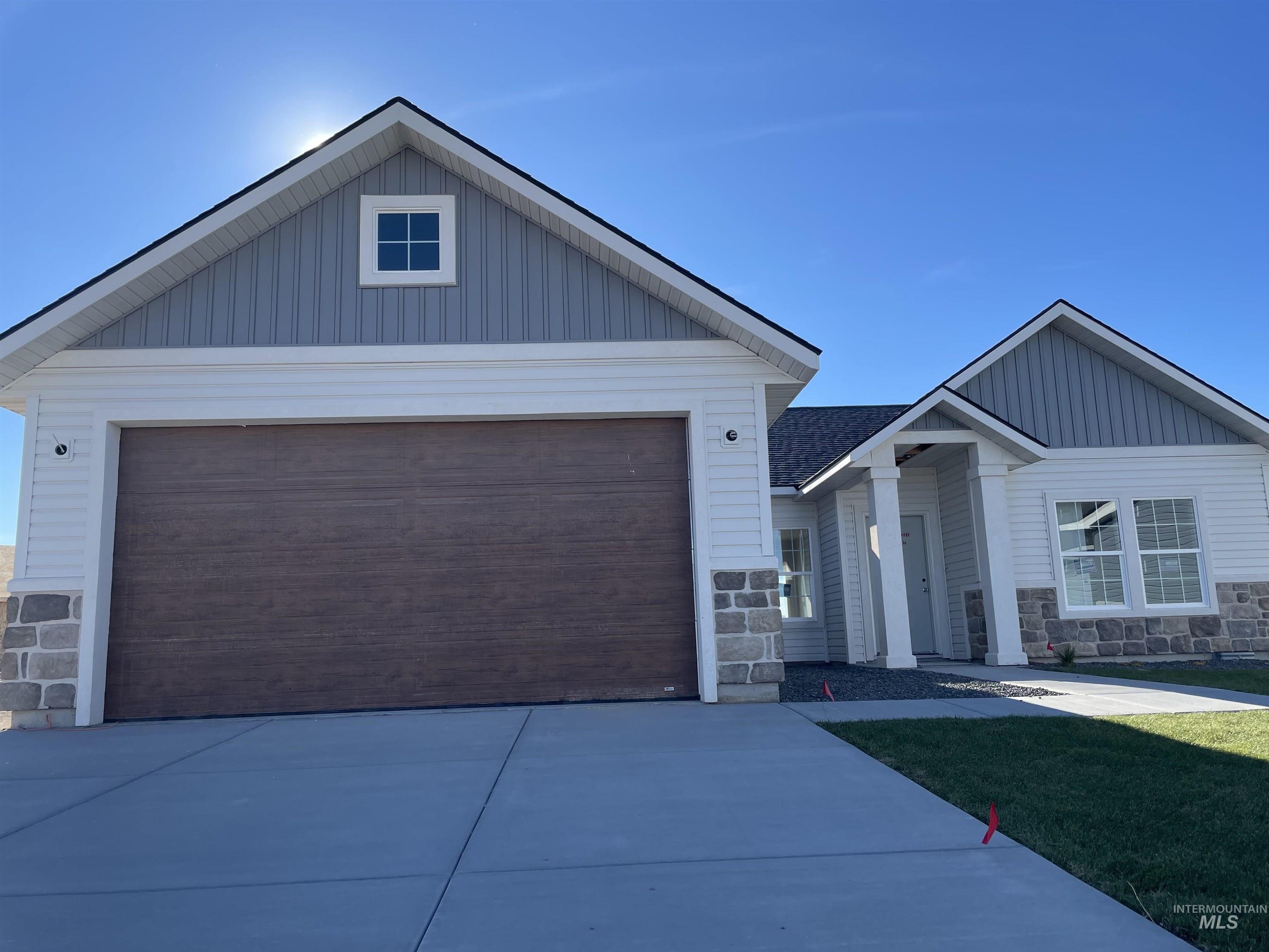 2064 Harrison Street South Twin Falls, ID 83301 - Photo 1 of 29 View of front of property with stone siding, a garage, board and batten siding, and driveway