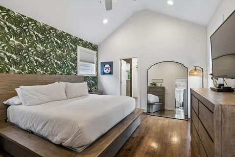 a bedroom with a bed and a flat screen tv