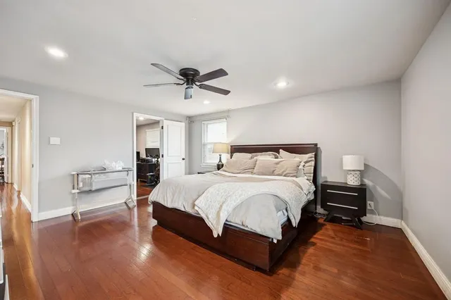 a large bedroom with a bed and a chandelier