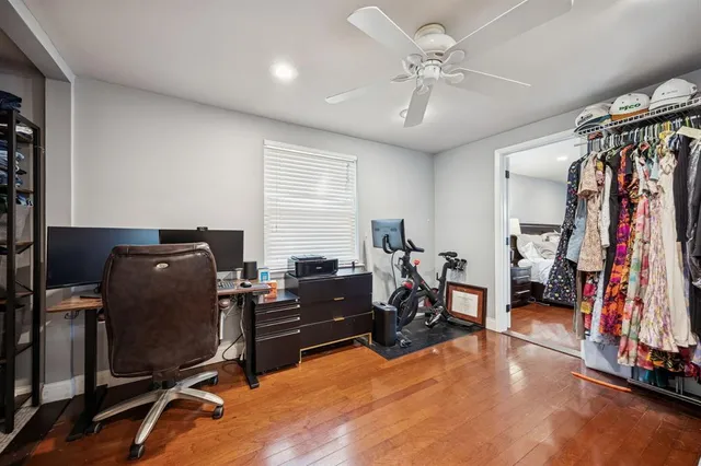 a view of a workspace with furniture and a window