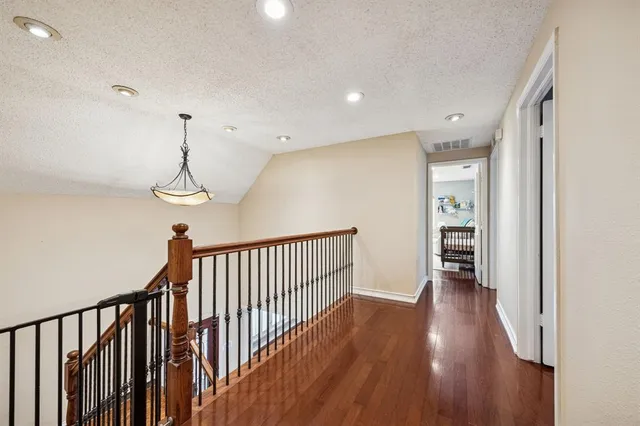 a view of hallway with wooden floor