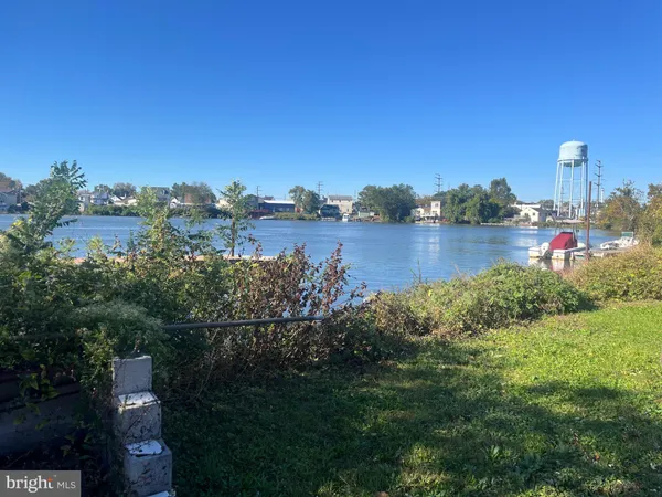 a view of a lake with houses in the back