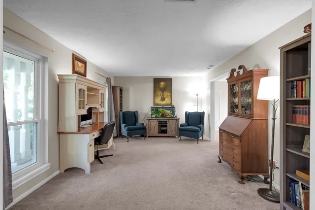 a view of a livingroom with furniture and windows