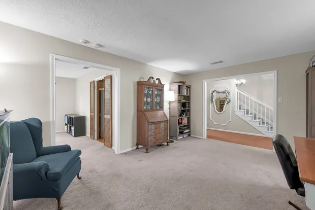 a living room with furniture and hallway view