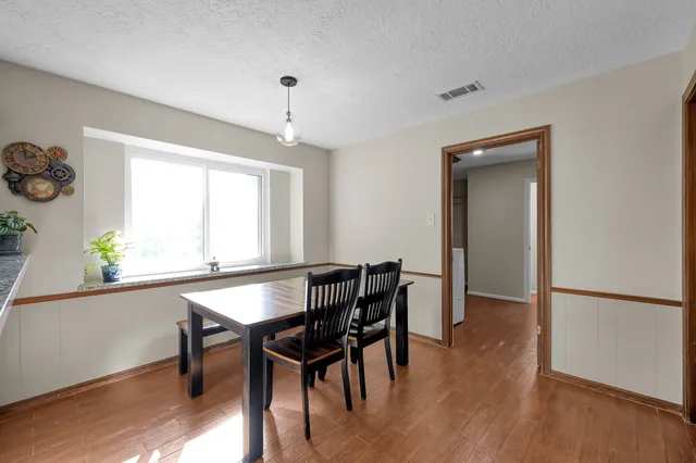 a view of a dining room with furniture window and wooden floor