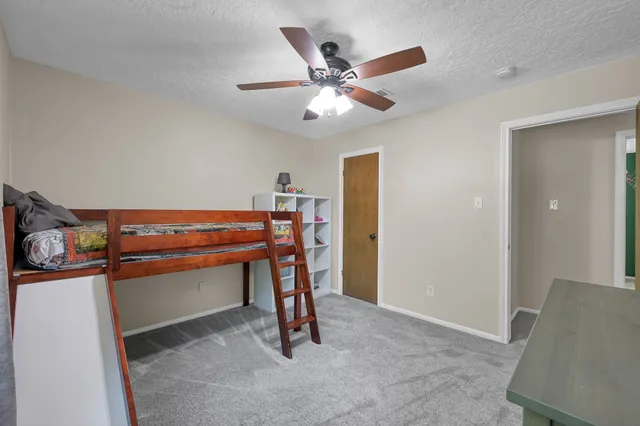 a view of room with workspace and windows