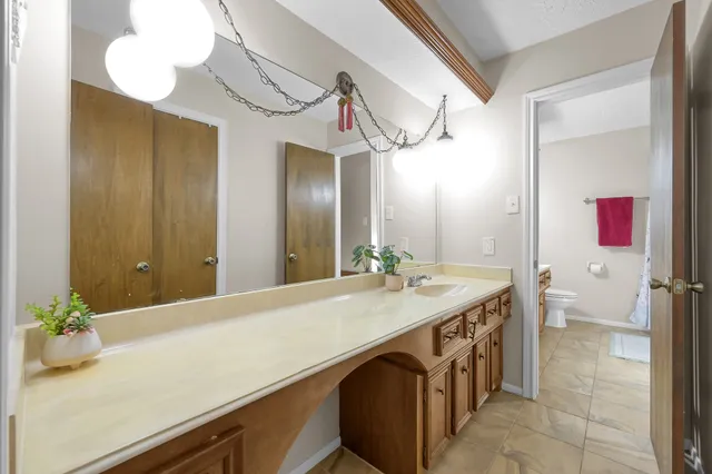 a bathroom with a sink a vanity and a mirror