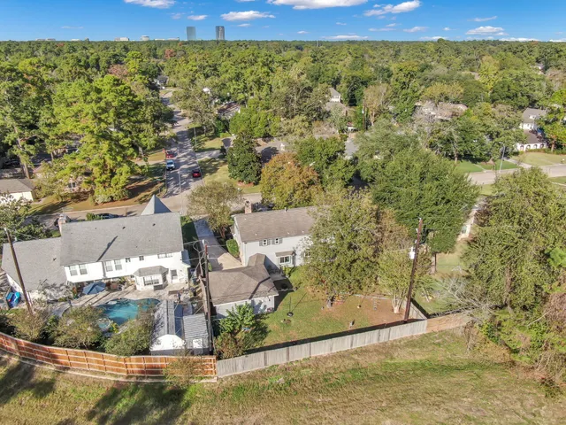 an aerial view of residential houses with outdoor space and river