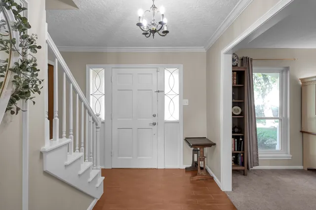a view of a hallway to a livingroom with furniture