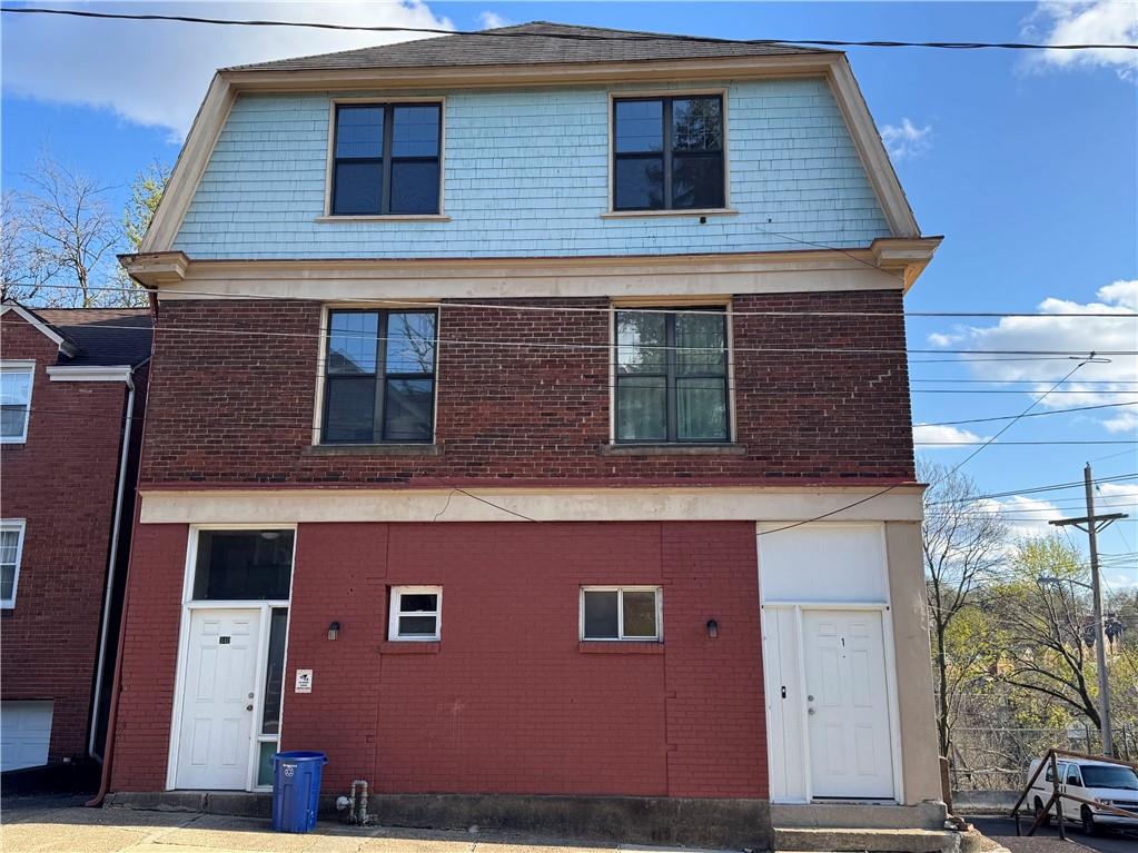 340 Rochelle Street, Unit 1 Pittsburgh, PA 15210 - Photo 1 of 5 a red brick building with glass windows