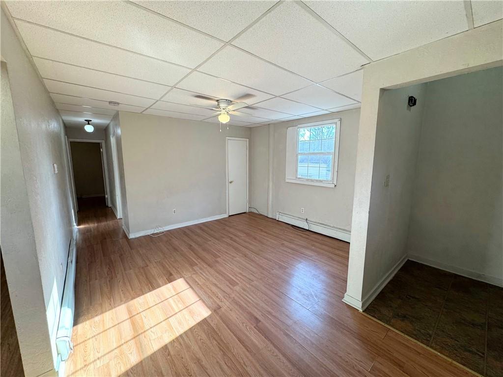 340 Rochelle Street, Unit 1 Pittsburgh, PA 15210 - Photo 2 of 5 an empty room with wooden floor and windows