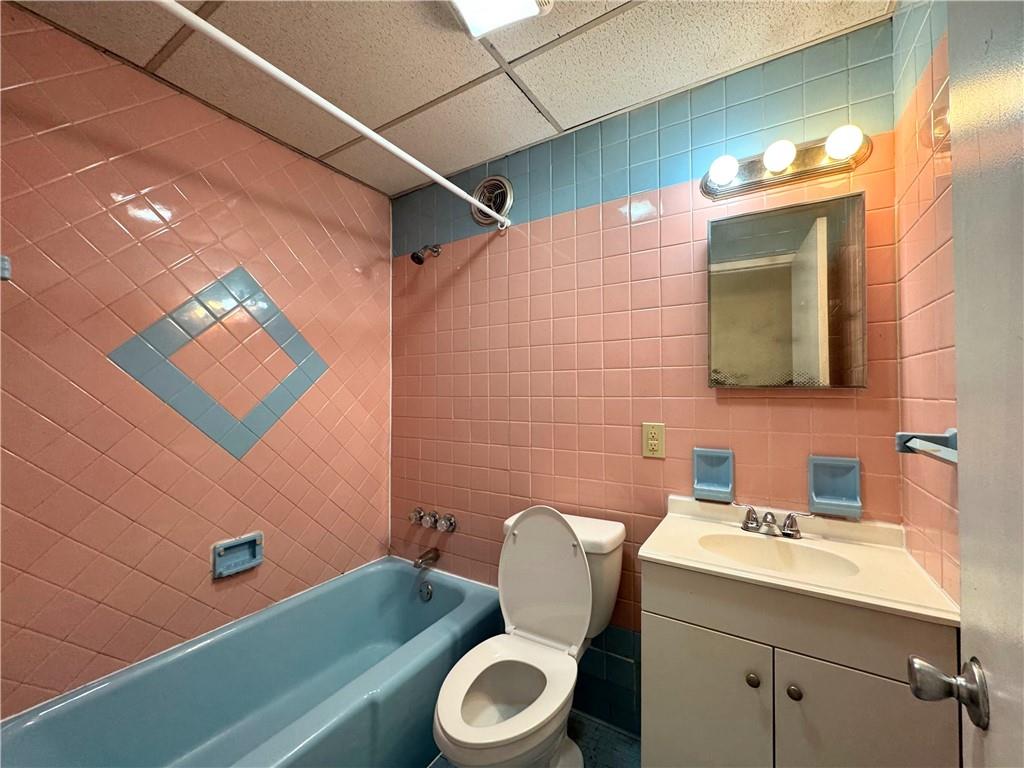 340 Rochelle Street, Unit 1 Pittsburgh, PA 15210 - Photo 4 of 5 a bathroom with a sink toilet and mirror