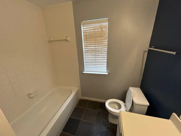 a bathroom with a toilet a sink and bathtub